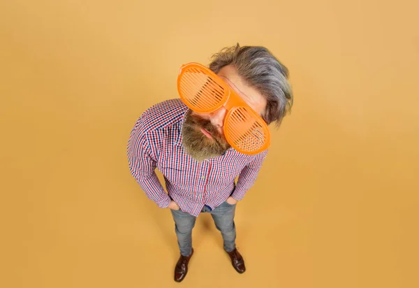 Stylish bearded man in big glasses. Funny man in shutter shade sunglasses. Sales and discount. Summer. Travel and vacation. Guy in checkered shirt and shutter shades big sunglasses. Stylish accessory