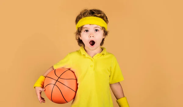 stock image Active sport lifestyle, childhood. Basketball training session for kids. Surprised boy with basketball ball. Little basketballer in sportswear. Sport equipment. Professional sport. Sport for children