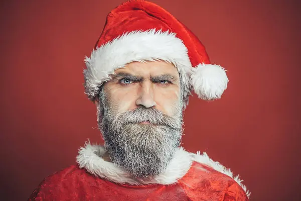 Astonished Santa Claus. Christmas man with beard. Holidays and celebrations. Handsome man with snowy beard wearing santa cap. Winter and Christmas time.