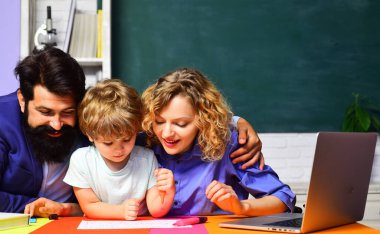 Okuldaki ilk günüm. Annesi ve babası ödev yapan küçük bir çocuk. Sınıfta ders çalışan sevimli bir çocuk. Özel ders. Erkek ve kadın öğretmenler ilkokuldan çocuğun okul ödevlerine yardım ediyorlar.