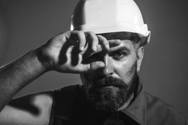 Tired builder in safety helmet. Hard work at construction site. Fatigued industrial worker wipes sweat from forehead. Heavy profession. Male architect, engineer in protective hardhat. Black and white clipart