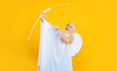 Sevgililer Günü kutlaması. Ok ve yaylı sevgililer günü meleği. Melek kanatlarıyla gülümseyen sakallı adam yaydan aşk oku atıyor. Aşk Tanrısı. 14 Şubat. Ok ve yaylı erkek melek