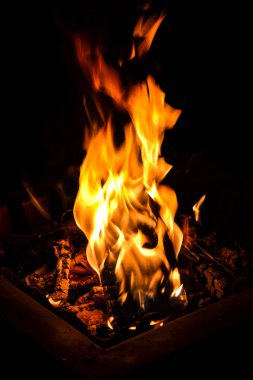 Fire pit glowing flames burning in the dark. Glowing red coals and campfire at Night clipart