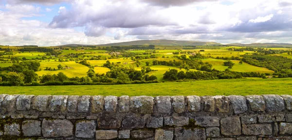 English countryside and farmland landscape panorama background along Hadrian\'s Wall Roman ruin. Beautiful rural country side pastures in England