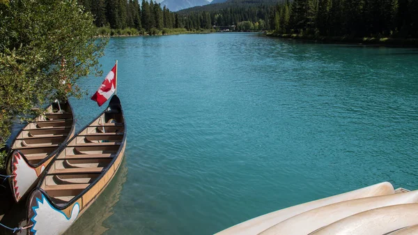 Canoe Boat Docked Shore Turquoise Water Bow River Canada Flag Stock Image