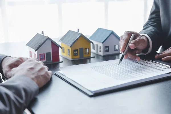Home sales,home rental and real estate concept.Customer sign the document after real estate agent explain about the terms of the home purchase or rental agreement