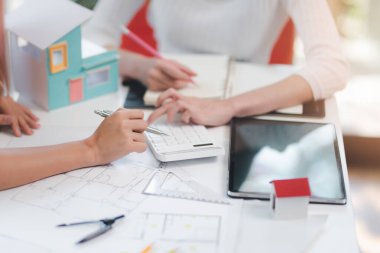 Construction and architect home building company concept, Engineers, architects and designers work together to design home or resident housing and validate blueprints in the workplace.