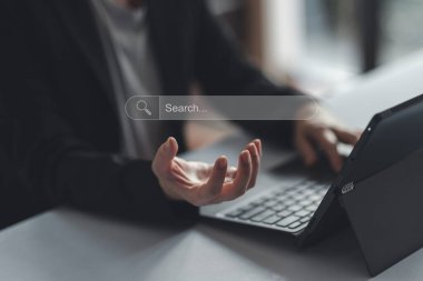 Concept of searching data networking and internet, Businesswoman wearing a suit acting like holding using smartphone searching data or browsing online data internet data for information