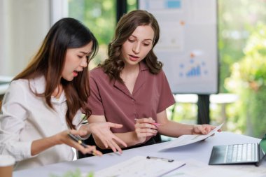 İş kadını çalışma kavramı, iş kadını gülümsemesi, iş yerindeki bilgisayarını kullanarak belge ve iş yatırımı grafik verilerini analiz ederek yatırım planı üzerinde çalışırken gülümsemesi..