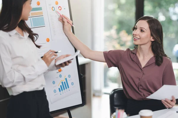 stock image Concept of business office woman working,Businesswoman smile while working about her invesment plan with analyzing document and business investment graph data by using laptop on desk in workstation.