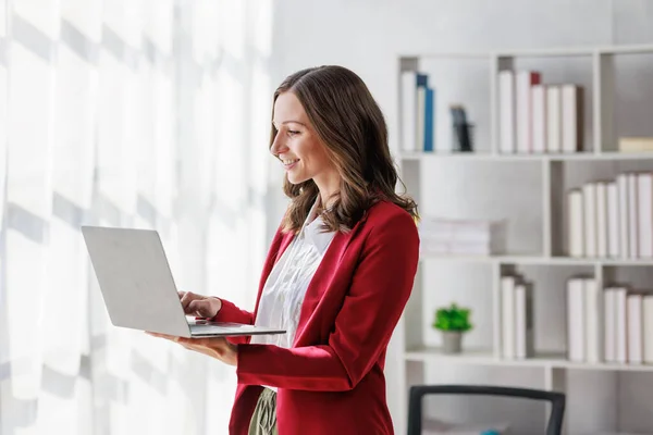 stock image Concept of business investment or working woman,  Businesswoman wearing a suit sitting and working on analysis of business investment documents and using computer to analytic business data.