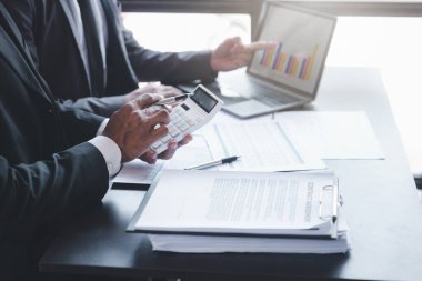 Finance and investment concept, Businessman present business finance investment plan with his partner, Investor colleagues discussing new investment plan by financial graph data on office table