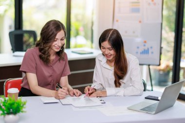 Concept of business investment or working woman, Closeup businesswoman discussing or working on analysis of business investment documents and using computer tablet to analytic business data.