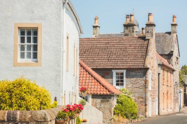 Fife, İskoçya, İngiltere 'de popüler bir film yeri olan ortaçağ Culross köyünün ana caddesindeki sevimli ve antika eski kasabalar ve harling ve taş kulübeler..