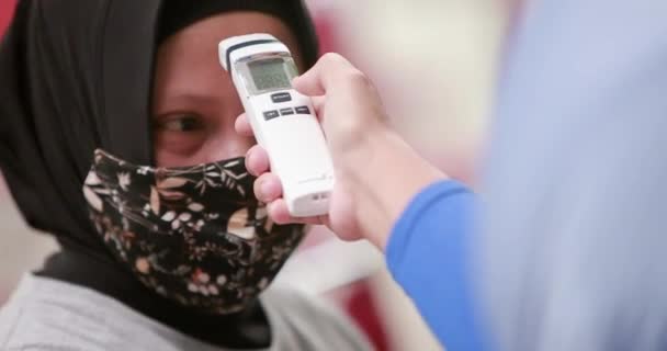 Γιατρός Εξετάζει Τον Ασθενή Χρησιμοποιώντας Μια Ψηφιακή Συσκευή Ελέγχου Θερμοκρασίας — Αρχείο Βίντεο