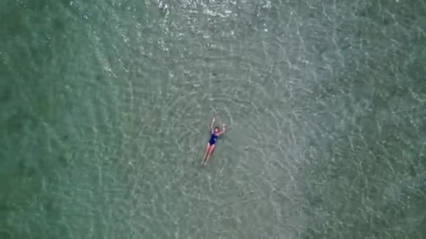Woman Blue Swimsuit Floating Crystal Clear Tropical Ocean Aerial Top — Stock Video