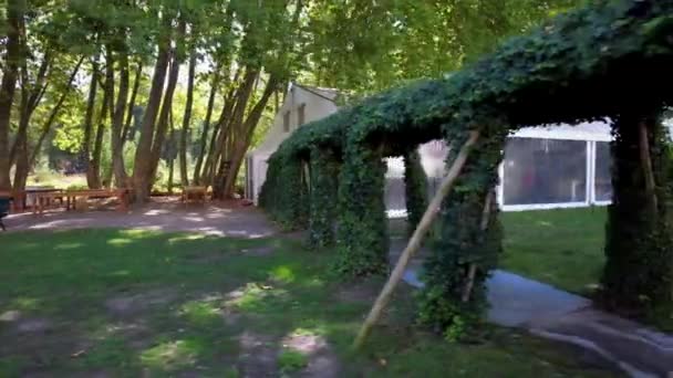 Ivy Vine Covered Corridor Tunnel Walkway Leading White Marquee Tent — Stock Video
