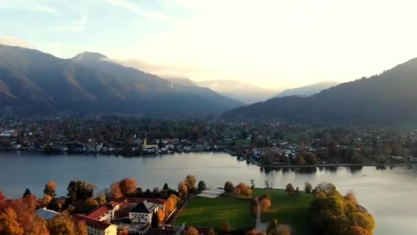 日没時にドイツの山の間に湖がある町の空中高波 — ストック動画