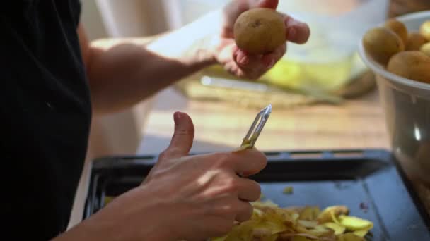 Woman Peeling Raw Potatoes Using Stainless Vegetable Peeler Selective Focus — Stock Video