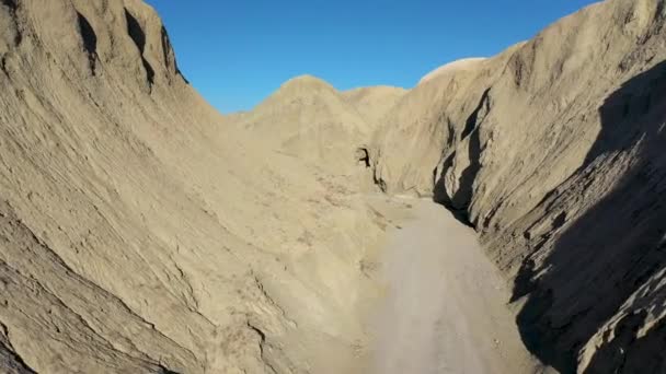 Aerial Flying Hillsides Formed Mud Caves Dirt Road Hot Dry — Stock Video