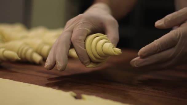 糕点厨师的手小心地将羊角面包摆放成一排准备烘焙 — 图库视频影像