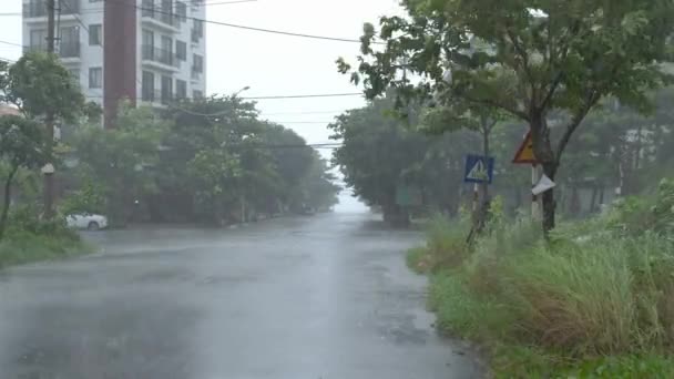 ベトナム ダナン市の湿式道路でオートバイに乗っている人々 嵐の豪雨 強い風と到来する台風シーン — ストック動画