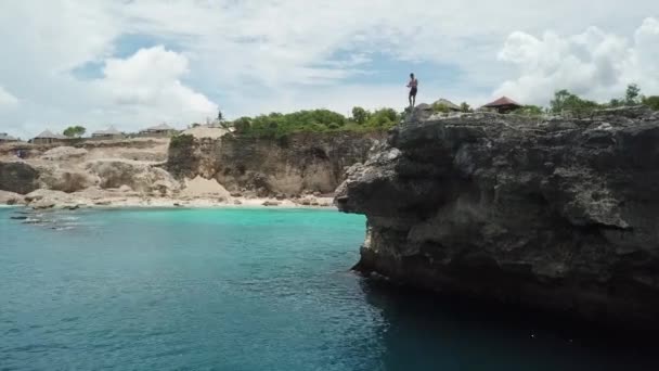 Young Male Does Backflip High Rock Cliff Tropical Water — Stock Video