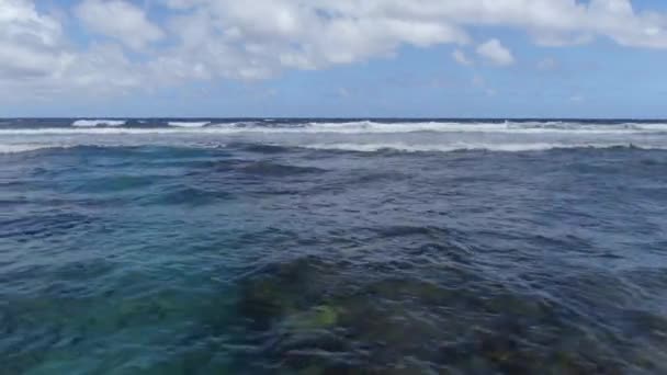 マウイ島で熱帯のサンゴ礁の上を回転する海の波 水の向こうにドローンのパンニング — ストック動画