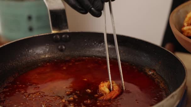 Cinematic Footage Chef Black Glove Gently Coating Cooked Shrimp Red — Stock Video