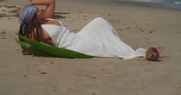 Young Female Lays Golden Brown Sand Caribbean Island Waves Crashing — Vídeos de Stock