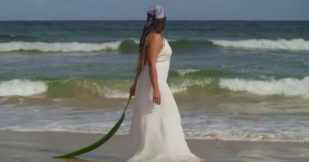 Young Girl Walking Beach Holding Palm Leaf While Wearing Beach — Video