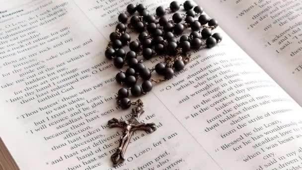Rosary Beads Placed Open Bible Close Panning Shot — Stockvideo