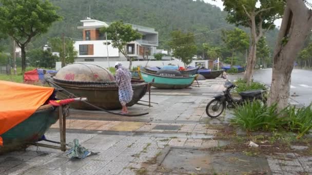 大雨でボートを結ぶレインコートの男 来る熱帯低気圧のための準備 ダナン ベトナム — ストック動画