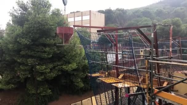 Concrete Bucket Suspended Crane Rainy Day Construction Site Working Building — Stock Video