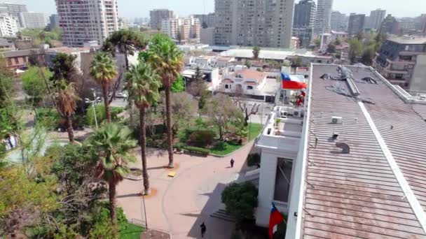 屋根の上にチリの旗と人々が晴れた日に歩くとUoa自治体の空の景色はドリー — ストック動画