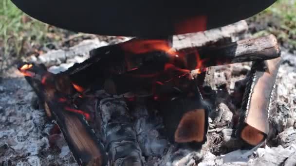 Wood Fire Burns Large Iron Kettle Cooking Goulash Outdoors — Stock Video