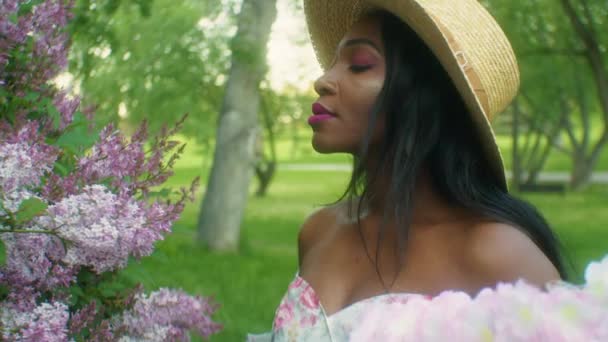 Black Woman Smelling Flowers Lilacs Close — Vídeos de Stock