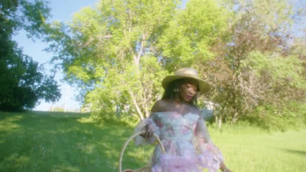 Black Woman Walking Park Smiling Dress Basket Low Angle — Video