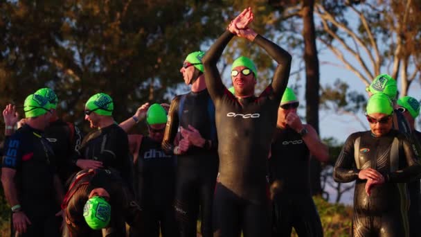 Group Athletes Wetsuits Goggles Stretching Triathlon Race Slow Motion — Vídeo de stock