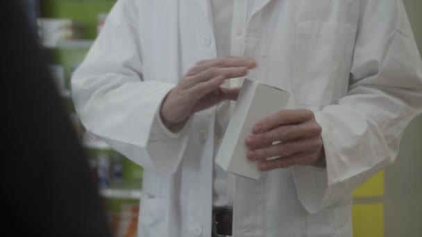 Pharmacist White Coat Opens White Box Brown Glass Bottle — Stock Video