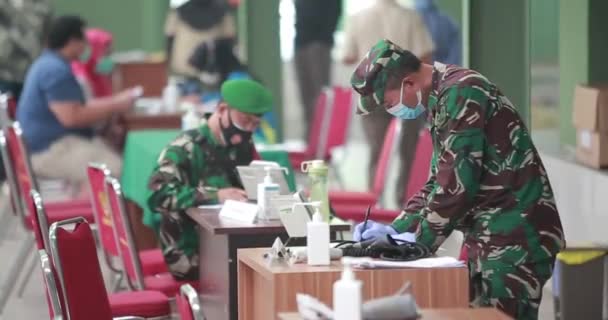 Два Врача Национальной Армии Индонезии Пишут Регистрируют Пациентов Стойке Регистрации — стоковое видео