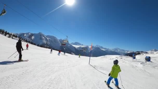 一个小男孩在滑雪板上跳下坡去 侧边是雪炮和滑雪电梯 Pov Shot — 图库视频影像