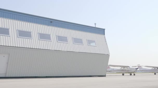 Airfield Hangar Doors Opening Revealing Parked Twin Engine Airplane — Vídeos de Stock