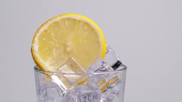 Cold Fresh Sparkling Water Pouring Glass Ice Lemon Slices Slow — Video