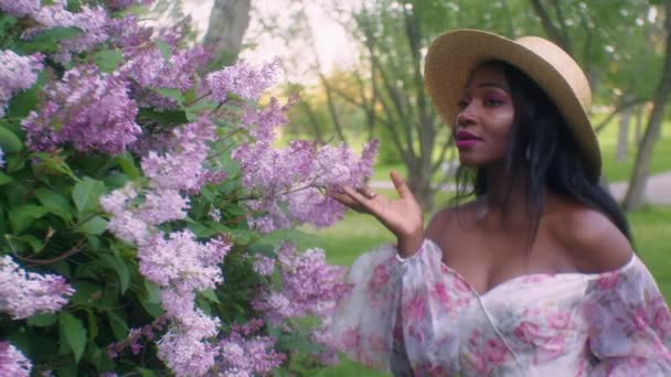 Black Lady Seductively Smells Touches Pink Lilac Flowers Park Eye — Vídeos de Stock