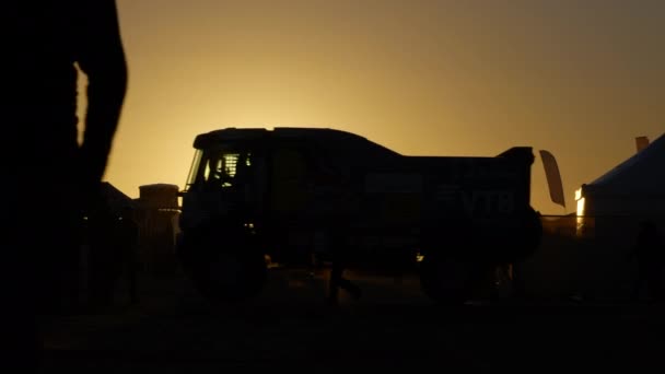 Tozlu Dakar Ralli Kampında Gün Batımının Altında Insan Araç Hareketleri — Stok video