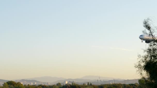 Slow Motion United Airlines Passagiersvliegtuig Vliegt Skyline Van Barcelona Weg — Stockvideo