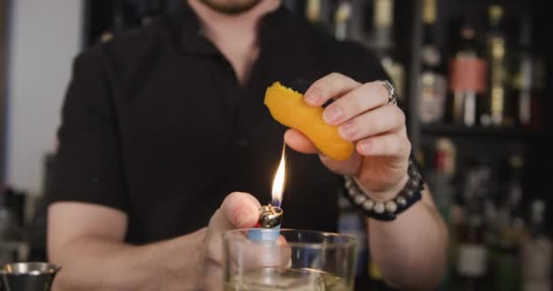 Bartender Spritzing Orange Peel Flame While Making Cocktail Slow Motion — Stock Video