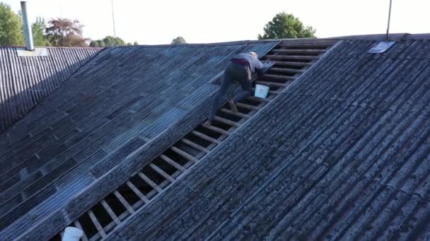 Worker Removing Old Asbestos Slate Roof Tiles Farmhouse Aerial View — Stock Video