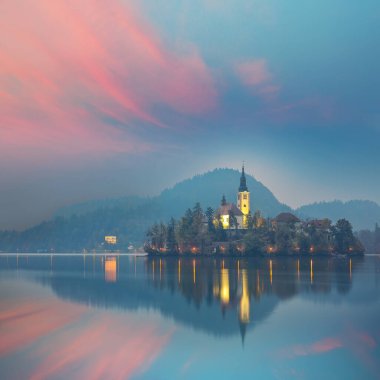 Astonishing night  view of popular tourist destination  Bled lake. Dramatic view of Pilgrimage Church of the Assumption of Maria. Location: Bled, Upper Carniolan region, Slovenia, Europe